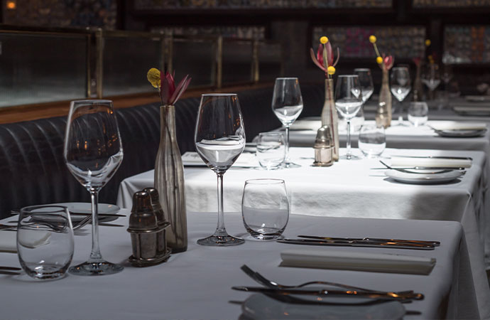 Interior of a modern restaurant with fine dining served for dinner