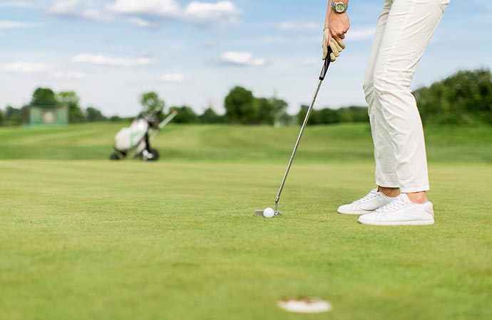 young woman playing golf courses insurance